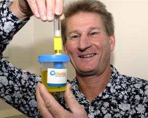 David Darling demonstrates one of the  Pacific Edge bladder cancer testing kits. Photo by Gregor...