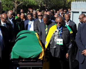 Delegates from the African National Congress transport the coffin of Nelson Mandela at his home...