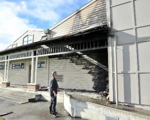 Detective Sergeant Brett Roberts examines the fire-damaged King's High School gymnasium, on...