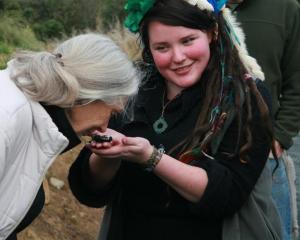 Dr  Jane Goodall  on a previous visit to Orokonui, gets to smell Kiwi poo. Photo by Neville Peat.
