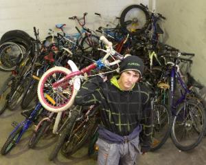 Dunedin Training Centre trainee Zane Grant (17) moves the consignment of Christchurch bikes...