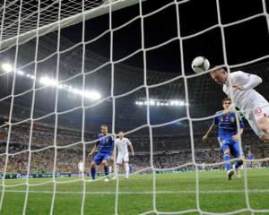 England's Wayne Rooney scores the only goal of the game.  REUTERS/Nigel Roddis