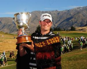 American Alex Prugh holds the trophy after winning the New Zealand Open at the Hills yesterday....