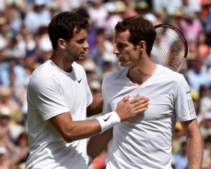 Grigor Dimitrov (L) speaks to Andy Murray after defeating him in their men's singles quarterfinal...