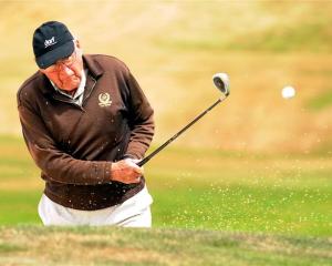 Ivan Elder, the oldest contestant in the New Zealand Masters Games, clears a bunker  at the St...