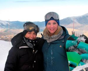 Lara Bingle (left) and Hayley Holt pause for a photo during filming at Coronet Peak yesterday....