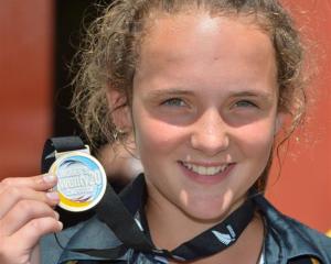 Legspinner Amelia Kerr  (14) displays her winner's medal after taking three wickets in her team's...