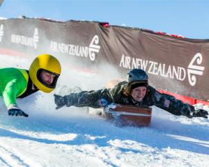 Matt Malcolm (left) and Kelly Zontine compete in  the 2012 suitcase race. Photo by Christina...