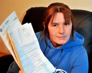 Milton process worker Danelle Byrne holds several IRD letters demanding she file an overdue GST...