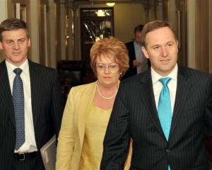 National leader John Key, right, with deputy Bill English and party president Judith Kirk arrive...