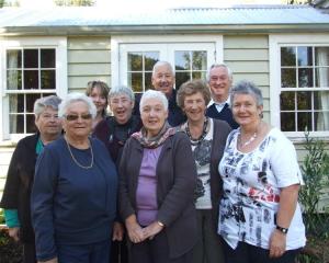 Nine of Thomas and Beatrice McMullan's grandchildren in front of the family cottage in Lawrence. ...