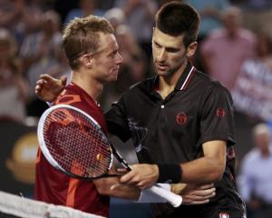 Novak Djokovic (R) of Serbia embraces Lleyton Hewitt of Australia after their match at the...