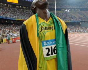 Nugget-fan Usain Bolt celebrates winning the gold and setting a new world record in the men's...