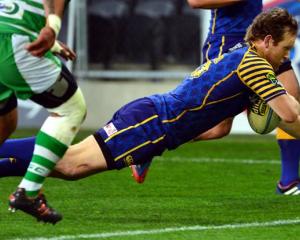 Otago fullback Peter Breen goes over to score a try.