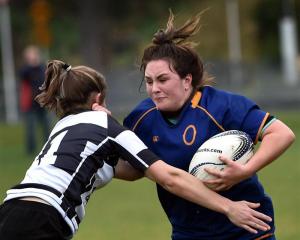 Otago Spirit hooker Tegan Hollows fends Hawkes Bay winger Felicity Powdrell at the University...