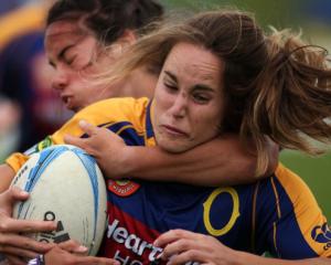 Phillipa Symes of Otago is caught by a Manawatu tackler. Photo Getty Images