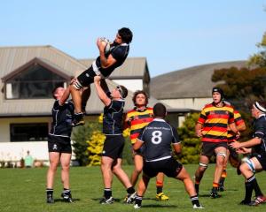 Pirates lock Andrew Johnson takes a kick-off as he is supported by Clinton Garrity (left) and...