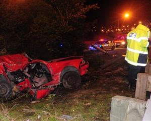 Police attend a serious accident on the Southern Motorway near Green Island on Saturday night....