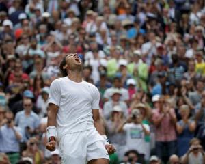 Rafael Nadal celebrates after defeating Lukas Rosol. REUTERS/Max Rossi