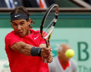 Rafael Nadal of Spain returns the ball to Novak Djokovic of Serbia during their singles final at...