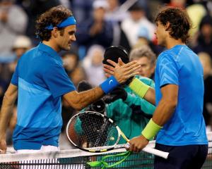 Roger Federer of Switzerland (L) shakes hands with Rafael Nadal of Spain after defeating him in...