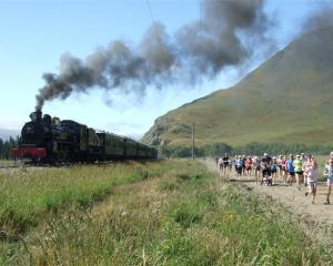 Runners race the Kingston Flyer during the second Race the Train event. Photo by Christina McDonald.