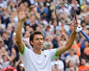 Sergiy Stakhovsky of Ukraine reacts after defeating Roger Federer of Switzerland in their men's...