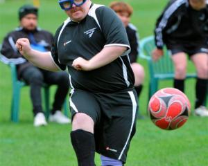 Shaun Crabtree, of Hawkes Bay, flicking a deft pass during a football match at the University Oval.