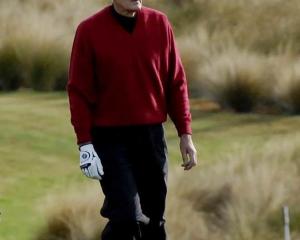 Sir Bob Charles walks down the fairway on the 14th hole on Thursday at the Michael Hill NZ Open....