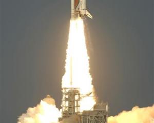 Space shuttle Discovery lifts off from the Kennedy Space Centre in Cape Canaveral, Florida on its...