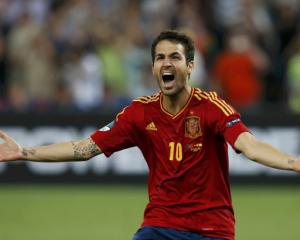 Spain's Cesc Fabregas reacts after scoring the winning penalty goal against Portugal during the...