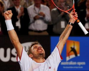 Stanislas Wawrinka celebrates his win over Novak Djokovic. REUTERS/Petar Kujundzic