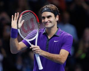 Switzerland's Roger Federer celebrates winning his men's singles semifinal against Britain's Andy...