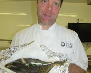 Tim Lynch and his freshly caught and cooked flounder. Photo by Pene Spencer.