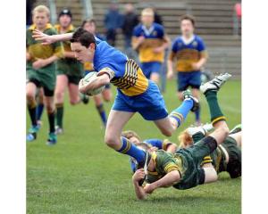 Lewis Kelly of Taieri with the ball is tackled by Mikaire Schooner of Eastern in the under 13...