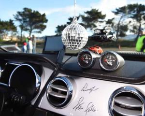 A disco globe and signatures from famous American race car driver Parnelli Jones and high...