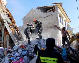 Rescue team members search for victims at a collapsed building in the village of Vrissa on the Greek island of Lesbos. Photo: Reuters