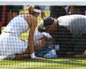 American Bethanie Mattek-Sands receives treatment from the medical team and later retires from...