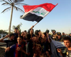 Iraqi Federal police and boys celebrate in West Mosul. Photo: Reuters