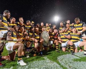 Captain Angus Ta'avao of Taranaki and his team mates pose with the Ranfurly Shield their win...