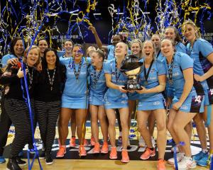 The Southern Steel players and staff celebrate with the ANZ Premiership trophy  after beating the...