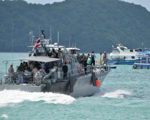 A Thai Royal Navy boat is seen during a searching operation for missing passengers of a capsized...