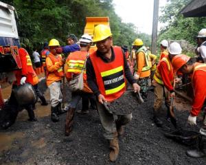 Rescue workers are seen near Tham Luang cave complex. Photo: Reuters