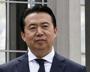 Interpol President Meng Hongwei poses during a visit to the headquarters of International Police...