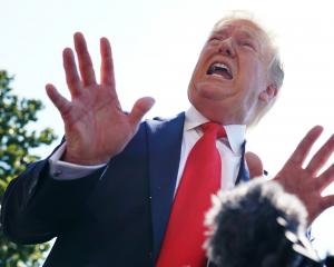 US President Donald Trump speaks to members of the media Friday prior to departing for his golf...