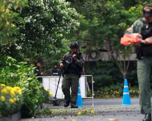 Police Explosive Ordnance Disposal (EOD) officers work following a small explosion at a site in...