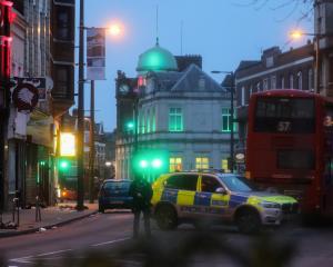 Police is seen near a site where a man was shot by armed officers in Streatham. Photo: Reuters