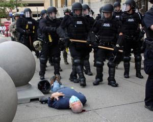 Martin Gugino lays on the ground after he was shoved by two Buffalo, New York, police officers...