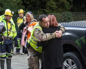 Anna Osborne, whose husband Milton died in the mine explosion, hugs a Pike River Recovery Agency...
