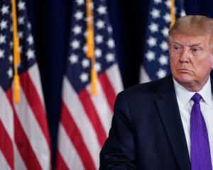 US President Donald Trump speaks during a news conference at Trump National Golf Club in...